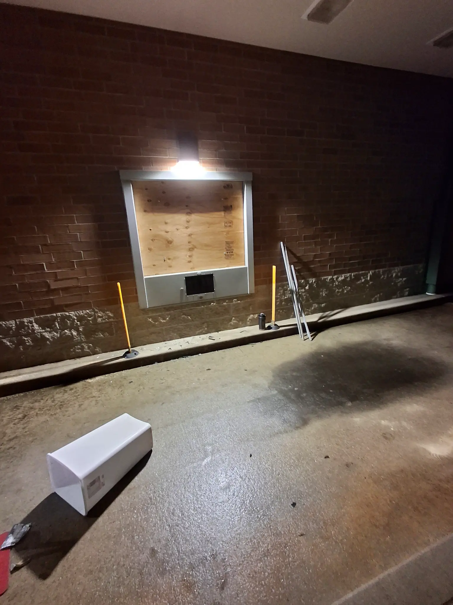 Commercial storefront fully boarded, secured, and lit — job complete