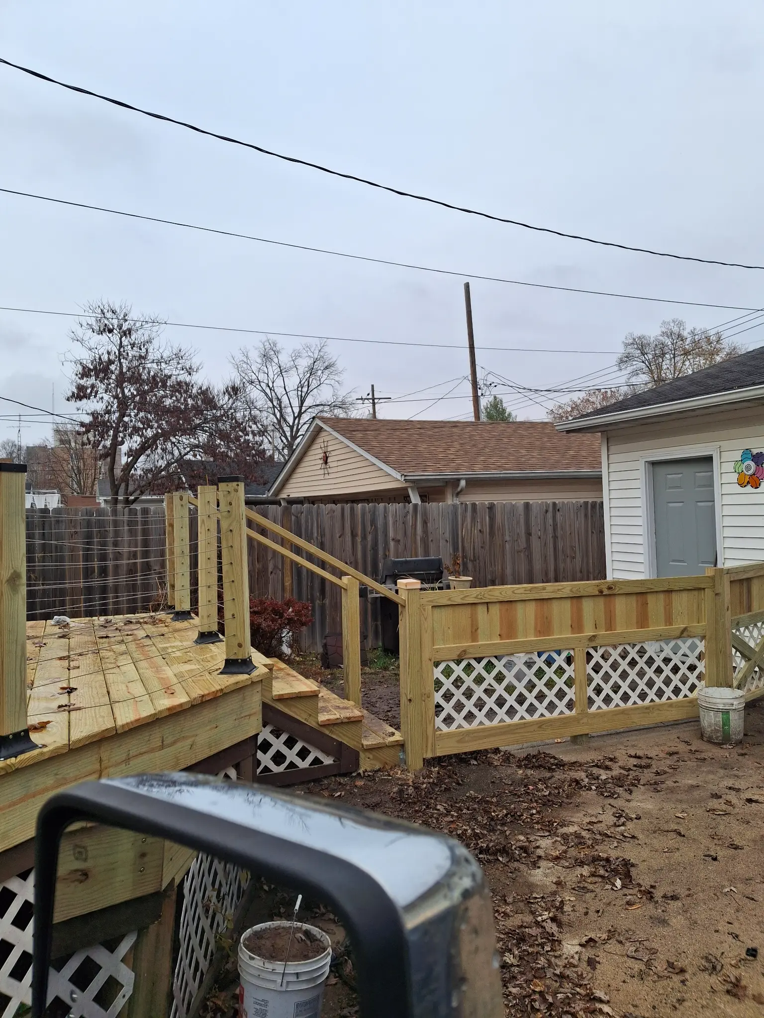 During: Deck framing in progress with cable railing posts being set