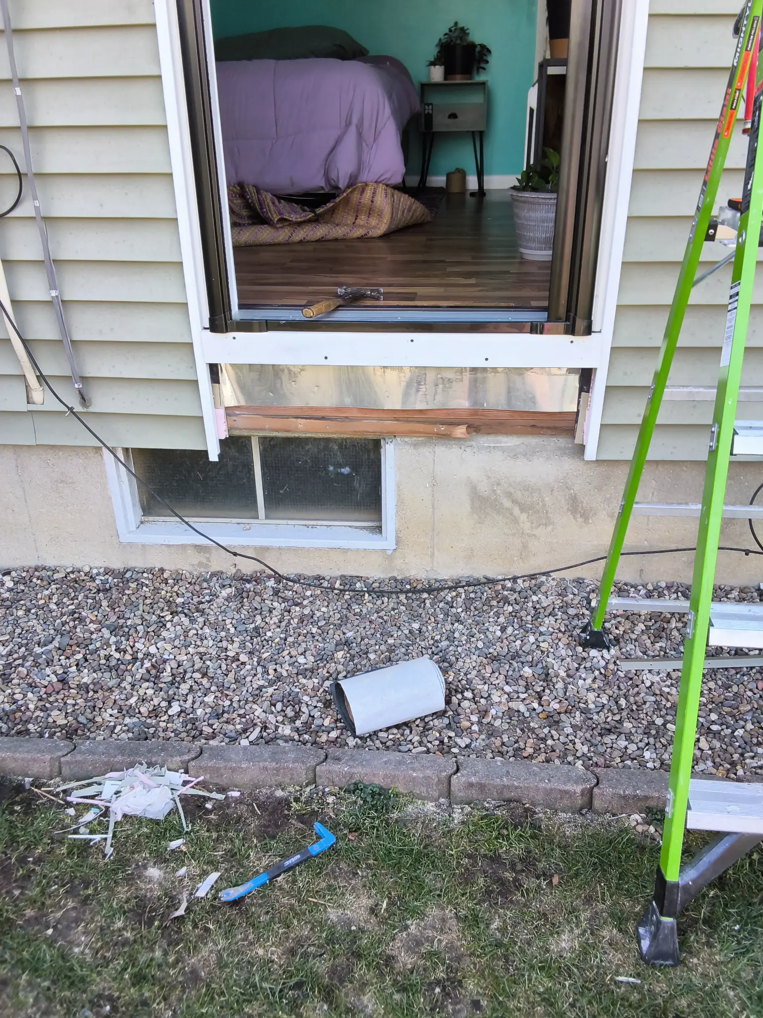 Before: Old door removed, rough opening exposed for new installation