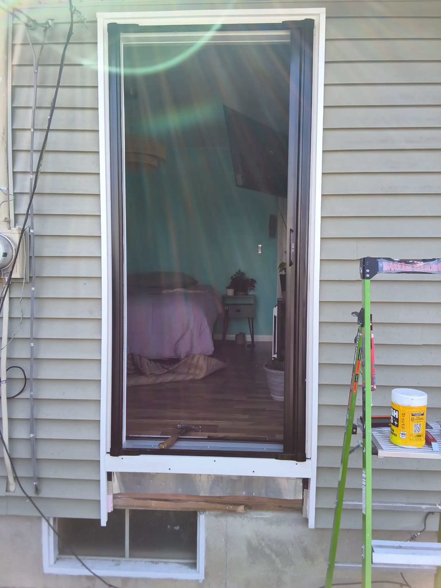New door being set in frame during residential door installation