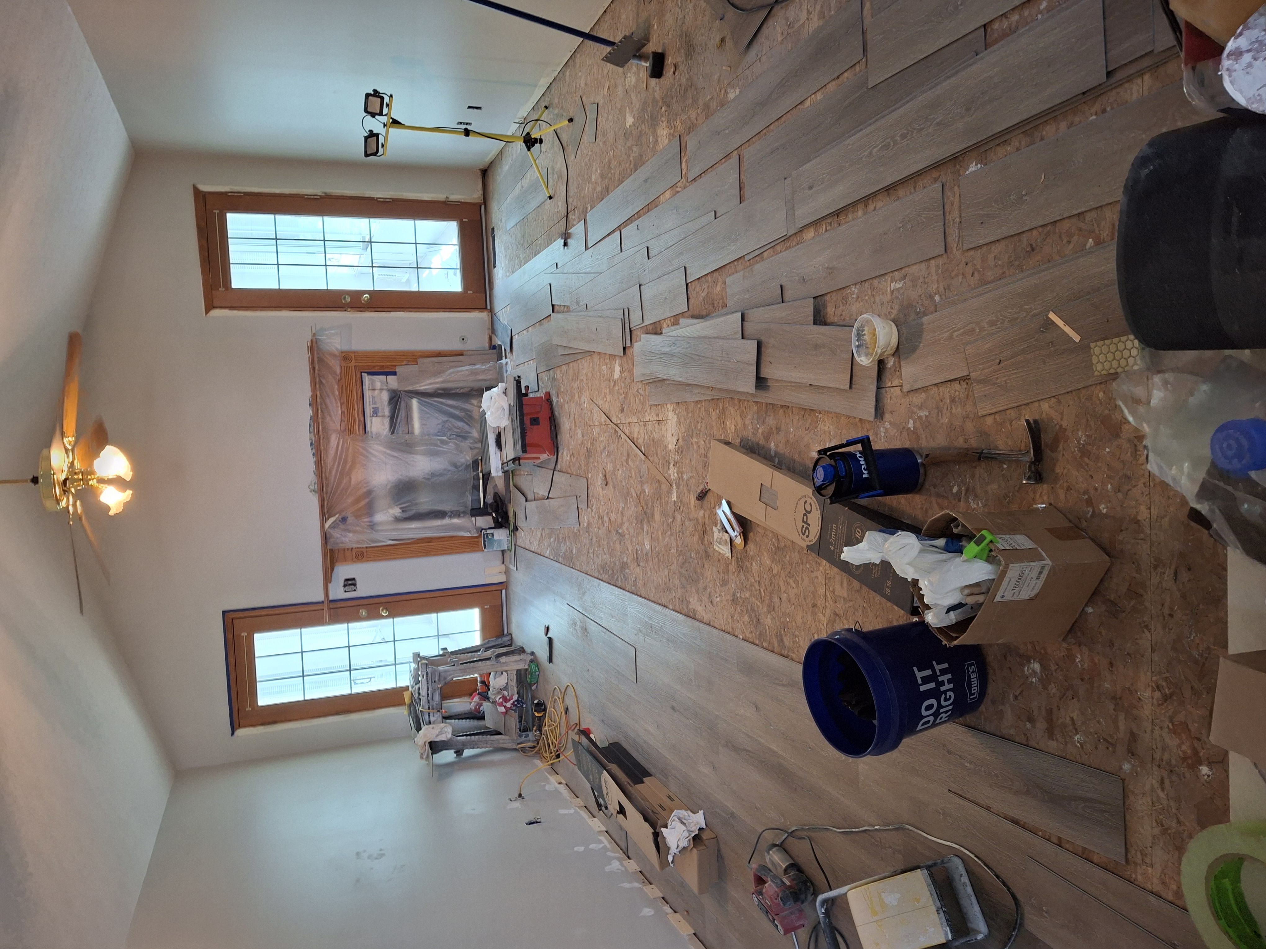LVP flooring installation in progress in large living room