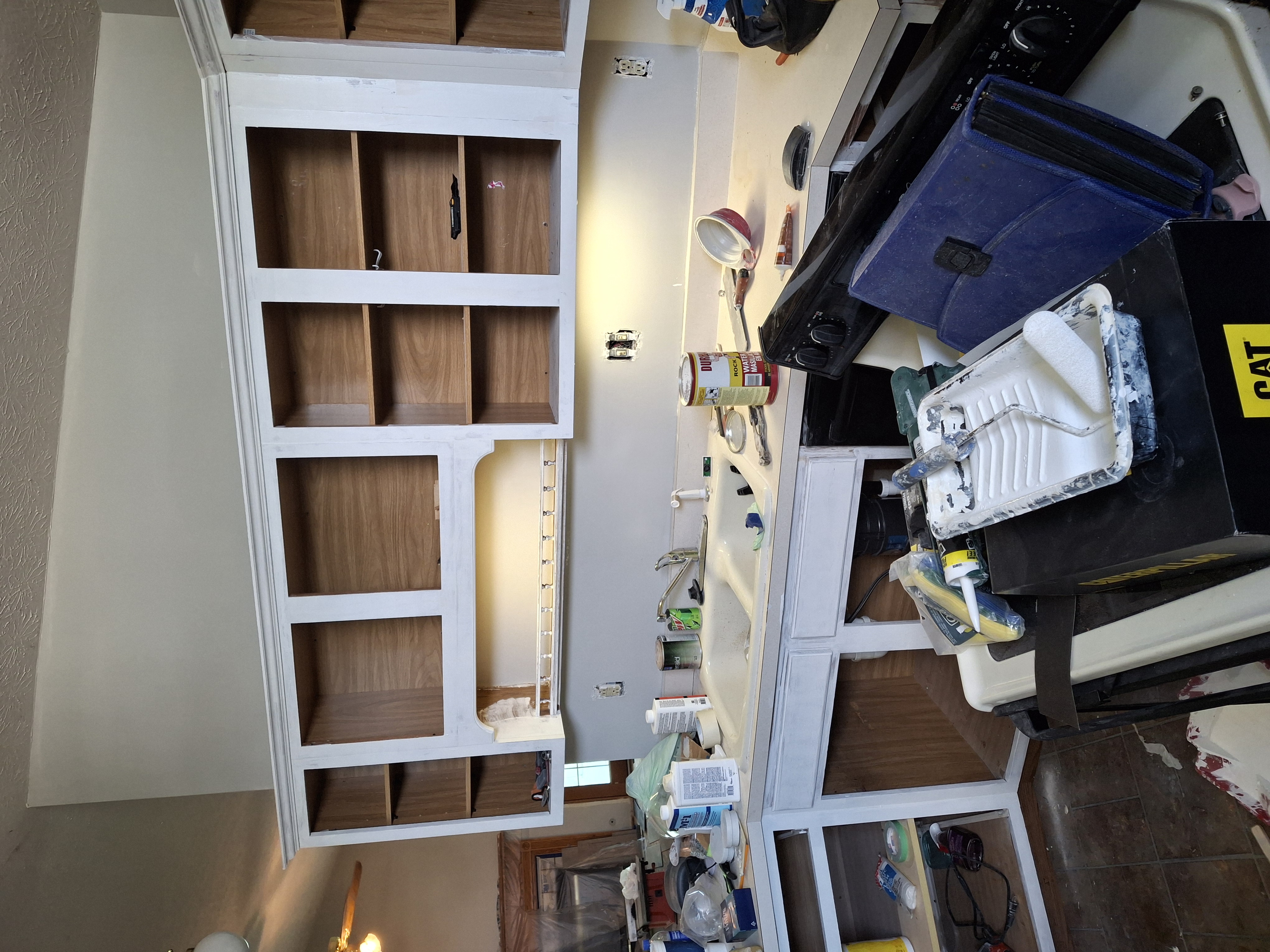 After: Kitchen with freshly painted white cabinets and new LVP flooring