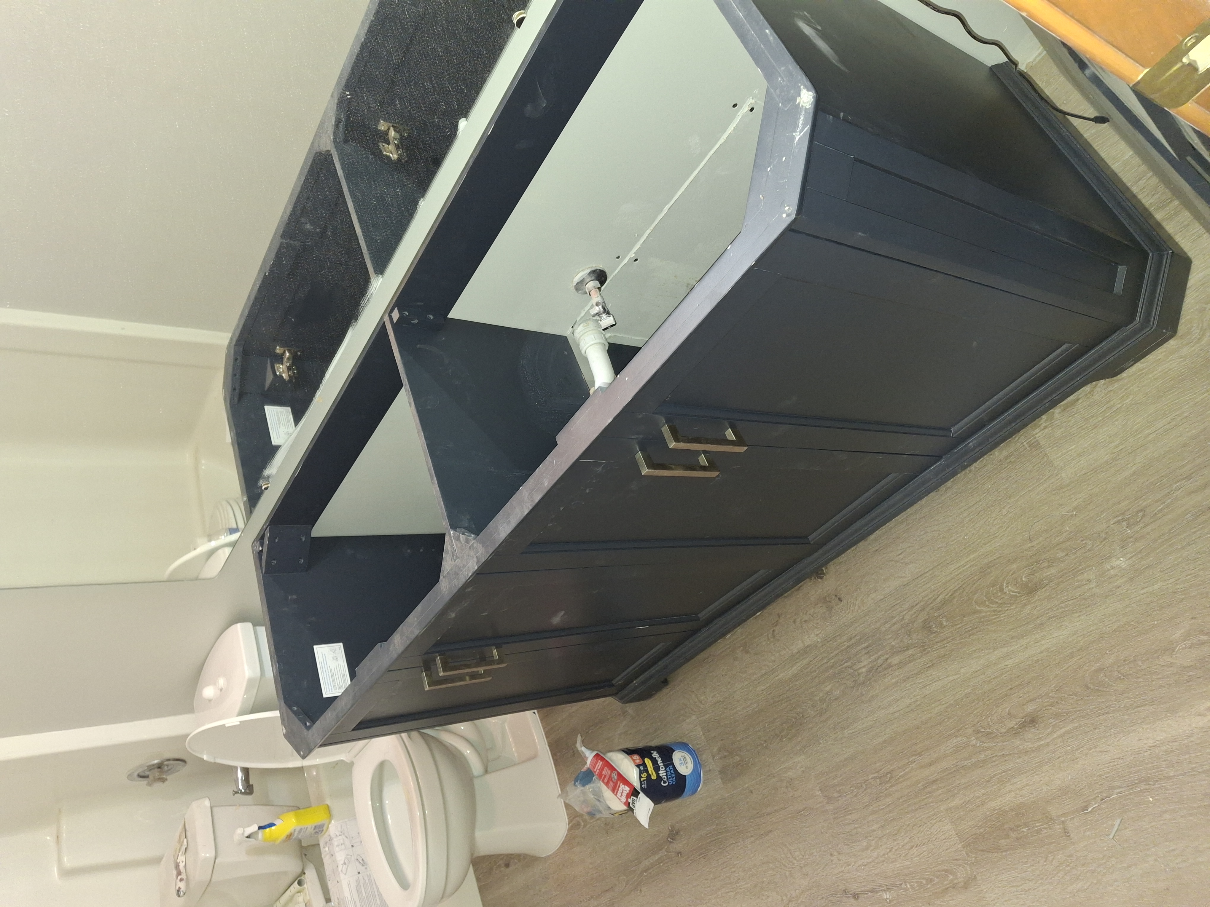 Before: Bathroom vanity cabinet being installed